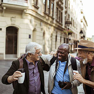 Close up of a group of male senior tourists exploring the city.