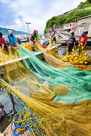 Fishermen preparing fishing nets and boats in Venezuela.