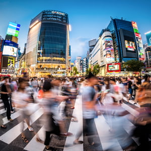Fisheye view of crowds of people at Shibuya Crossing in Tokyo, Japan.