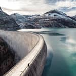 Emosson hydroelectric dam and lake surrounded by rocky landscape, in Switzerland.