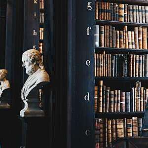 Vanishing perspective of marble busts lining the Long Room at the Old Library of Trinity College Dublin.