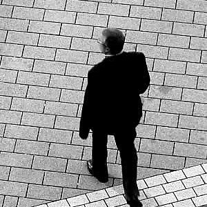 Man walking across pavement